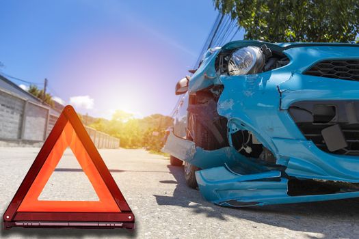 Front of blue color car big damaged and broken by accident on city street parking can not drive any more on road have triangle. With copy space for text or design