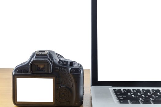 Laptop computer and digital camera have bank black screen of laptop and blank screen of back side digital camera on wood table isolate on white background.