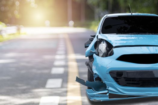 Front of blue color car big damaged and broken by accident on city street parking can not drive any more. With copy space for text or design
