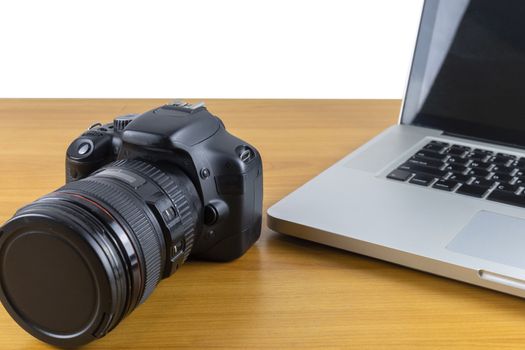 Digital camera and laptop on wood table isolate on white background