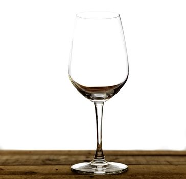 Emty wine glass on wood table. Isolate on white background.