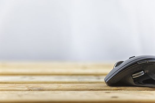 Office concept. Close up head mouse on wood table and white background with copy spce for text or design.