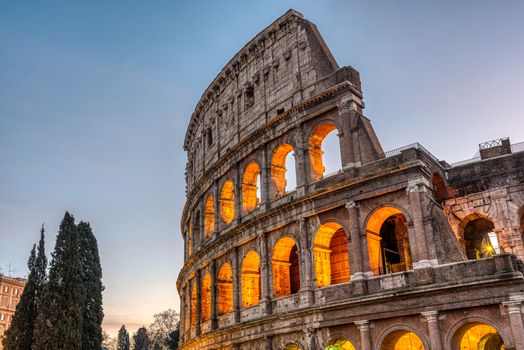 Detail of the illuminated Colosseum in Rome at dawn