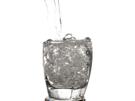water splashing to glass overflow isolated on white background