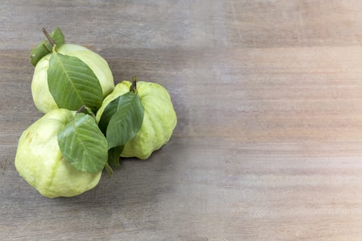 Fresh guava fruit on wood table with copy space for text or design.