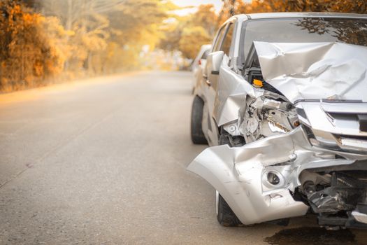 Autumn road front of light gray color car with pick up have big damaged and broken by accident on road in morning time can not drive any more park for wait insurance officer. Save with clipping path
