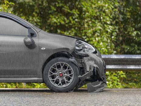 Raining day front of  gray color car have damaged and broken by accident on road parking can not dirve any more. With copy space for text or design
