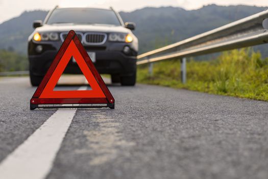 Phuket, Thailand - September 25, 2019 BMW X3 have problem stop and park on road with Red triangle, red emergency stop sign, red emergency symbol .