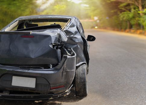 Back side of black color car big damaged and broken by accident on road parking can not drive any more. With copy space for text or design