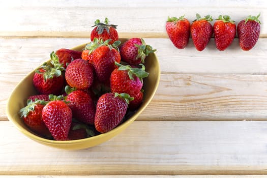 strawberrys in blow on the wood table with copy space for text or design.