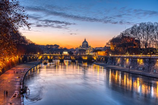 Dramatic sunset over the St. Peters Basilica and the river Tiber in Rome