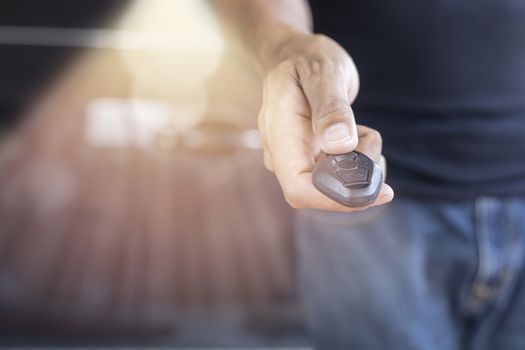 Car key remote on hand. Hand man giving a car key. 