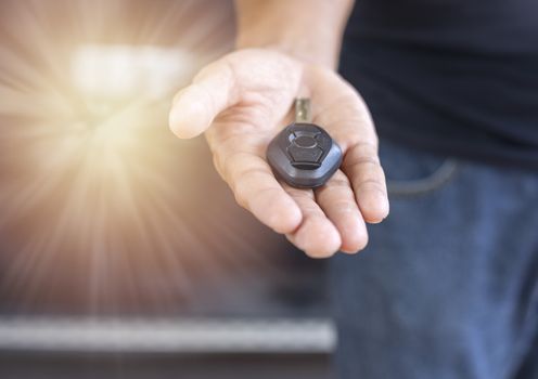 Car key remote on hand. Hand man giving a car key. 