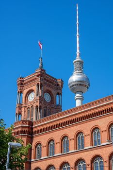 The famous Television Tower and the tower of the city hall in Berlin in front of a clear blue sky