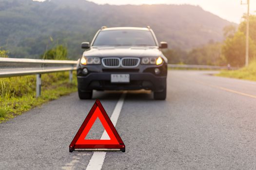 Phuket, Thailand - September 25, 2019 BMW X3 have problem stop and park on road with Red triangle, red emergency stop sign, red emergency symbol .