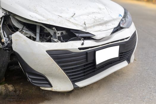 Front of white color car big damaged and broken by accident on road parking can not drive any more. With copy space for text or design