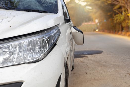 Car accident on road car door and rearview mirror  broken. Front of white color car damaged and broken by accident on road. Save with clipping path.