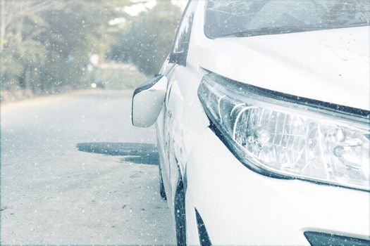 Car accident on winter road car door and rearview mirror  broken. Front of white color car damaged and broken by accident on winter road. Save with clipping path.
