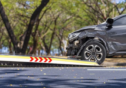 accident Car Slide on  truck for move. Balck car have damage by accident on road take with slide truck move . Isolate on white background.