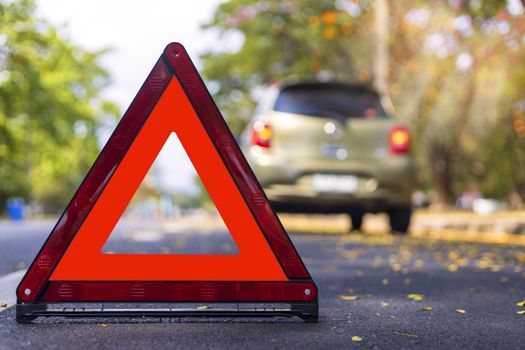 Red triangle, red emergency stop sign, red emergency symbol and  car stop and park on road.