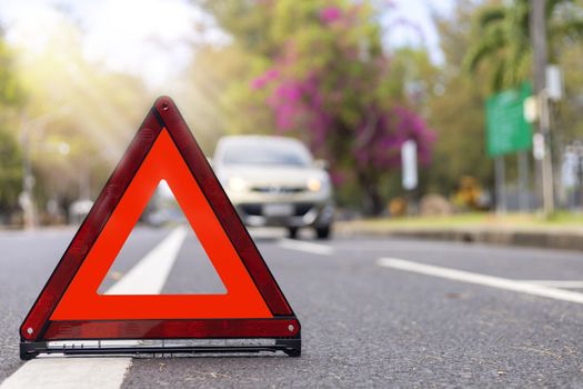 Red triangle, red emergency stop sign, red emergency symbol and  car stop and park on road.
