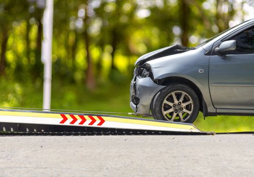 accident Car Slide on  truck for move. Gray car have damage by accident on road take with slide truck move . 