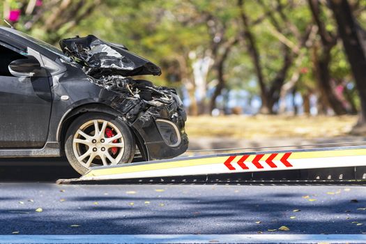 accident Car Slide on truck for move. Black car have damage by accident on road take with slide truck move . 