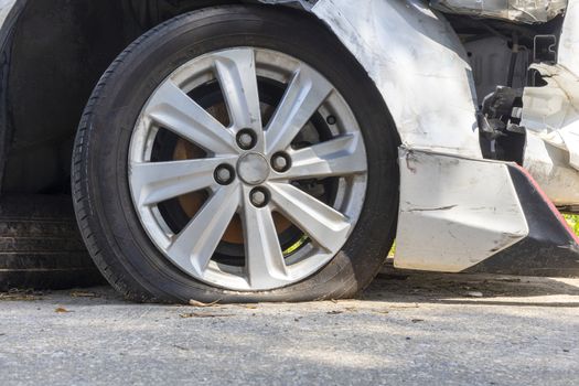 Broken tired, flat tire after front white car damaged and broken by accident isolated on white background. Save with clipping path. 