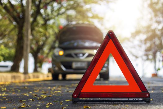 Red triangle, red emergency stop sign, red emergency symbol and  car stop and park on road.