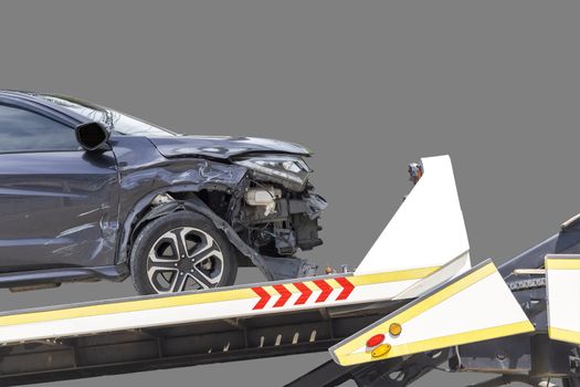 accident Car Slide on truck for move. Black car have damage by accident on road take with slide truck move . Isolated on gray background.