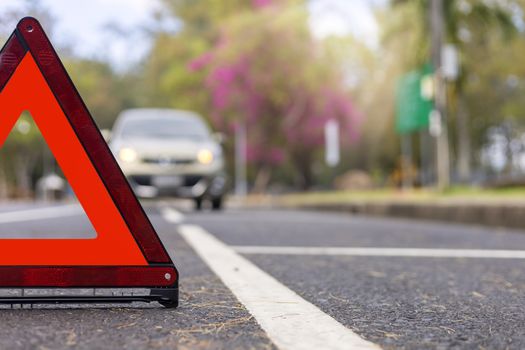 Red triangle, red emergency stop sign, red emergency symbol and  car stop and park on road.