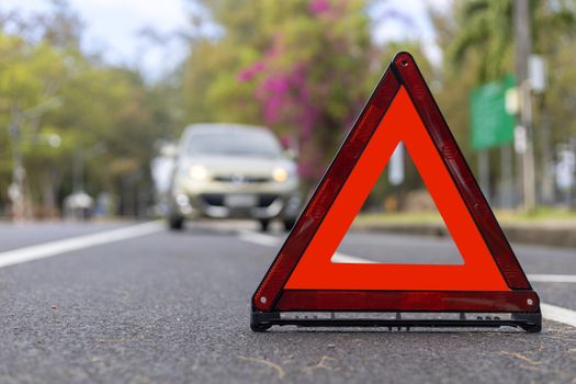 Red triangle, red emergency stop sign, red emergency symbol and  car stop and park on road.