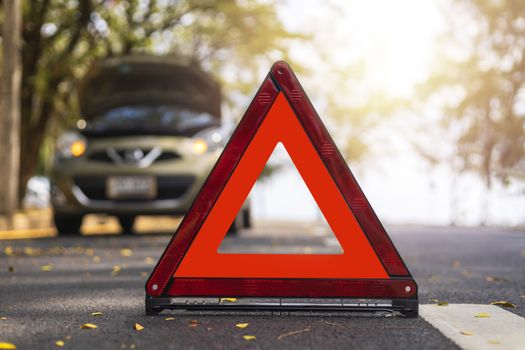 Red triangle, red emergency stop sign, red emergency symbol and  car stop and park on road.