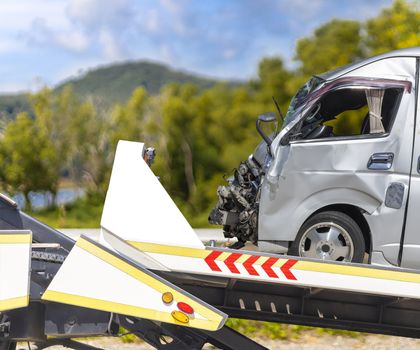 accident Car Slide on truck for move. van car have damage by accident on road take with slide truck move .