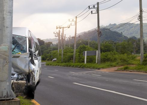 Car crash. Front of Van crash with electric pole  have damaged and broken by accident on traffic road .
