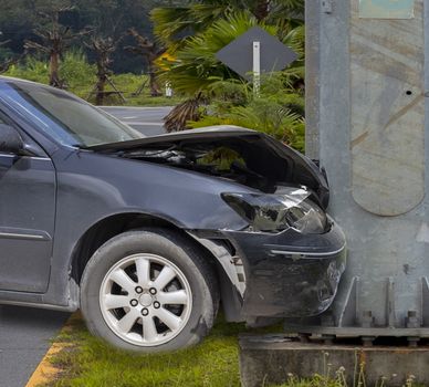 Car crash. Front of car crash with electric pole  have damaged and broken by accident on traffic road .