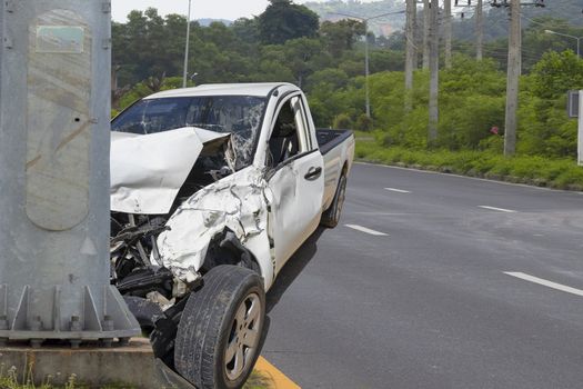 Car crash. Front of car crash with electric pole  have damaged and broken by accident on traffic road .