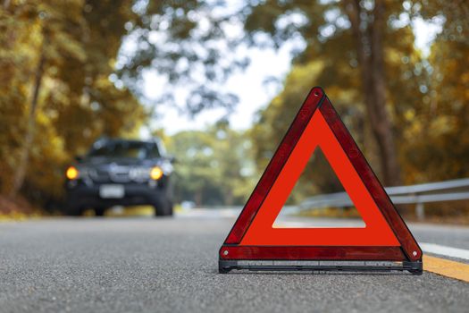 Black car have accident park on road. Red triangle, red emergency stop sign, red emergency symbol and black car stop and park on road.