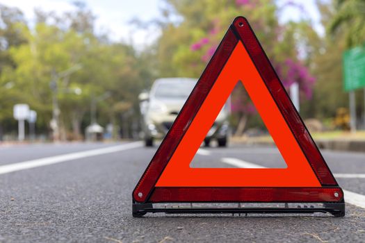 Red triangle, red emergency stop sign, red emergency symbol and  car stop and park on road.