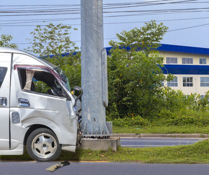 Car crash. Front of Van crash with electric pole  have damaged and broken by accident on traffic road .