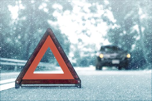 Snow time black car have accident park on road. Red triangle, red emergency stop sign, red emergency symbol and black car stop and park on road.