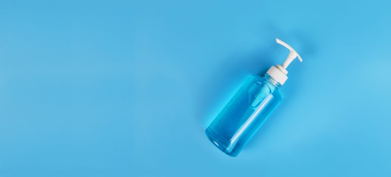 Blue alcohol gel isolated on blue background. Hand sanitizer gel for clean. Hand sanitizer in pump head bottle. with copy space.
