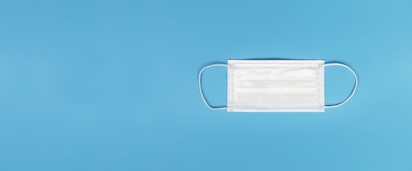 Medical mask isolated on blue background , Medical face mask isolated with copy space