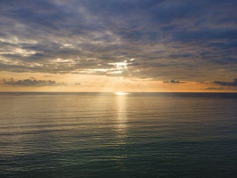 Aerial Drone view sunset over the sea with cloud and sun light with copy space.
