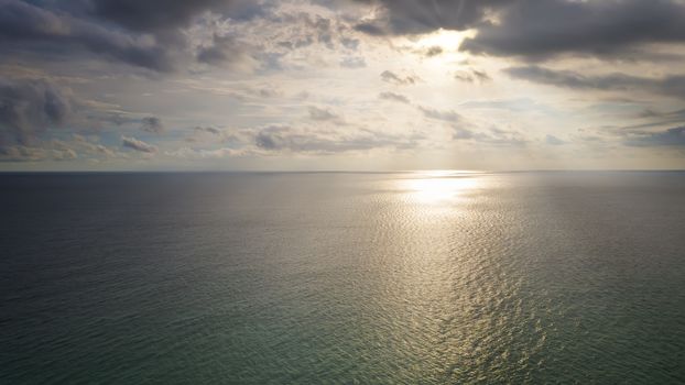 Aerial Drone view sunset over the sea with cloud and sun light with copy space.