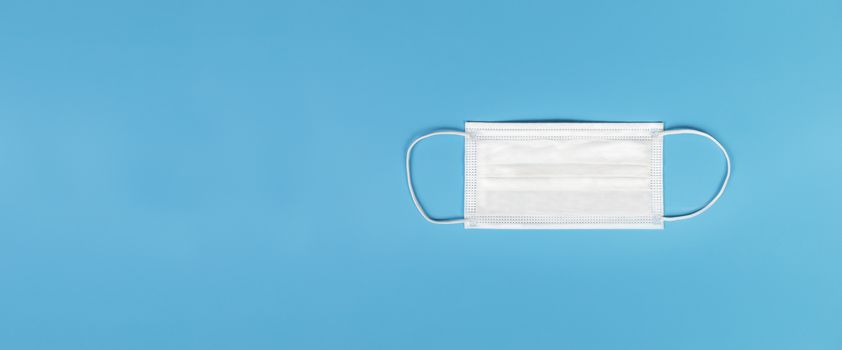 Medical mask isolated on blue background , Medical face mask isolated with copy space