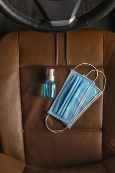 Top view Medical mask Alcohol Hand sanitizer gel on The car seat .