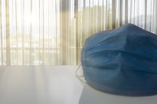 Medical protective mask on table with sunray background.