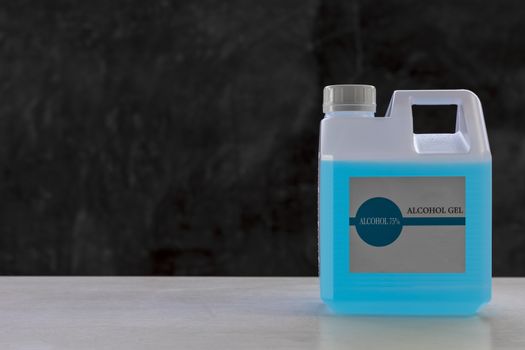 Blue alcohols gel on white table and  calcium oxide background. Hand sanitizer gel for clean. Hand sanitizer in 1 L. bottle. With copyspace for text or design.