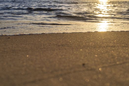 Soft wave from sea come to wet sand beach background. With copy space for text or design 